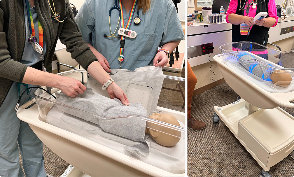 Hospital nurses wrapping a model infant inside a Snuglit Phototherapy system