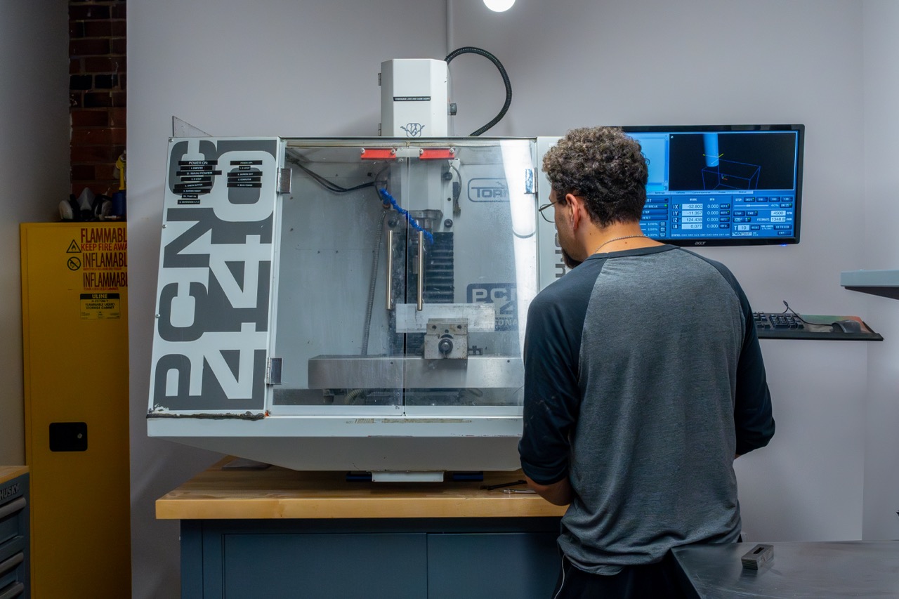 Engineer operating a CNC machine for medical device prototyping at Cortex Design