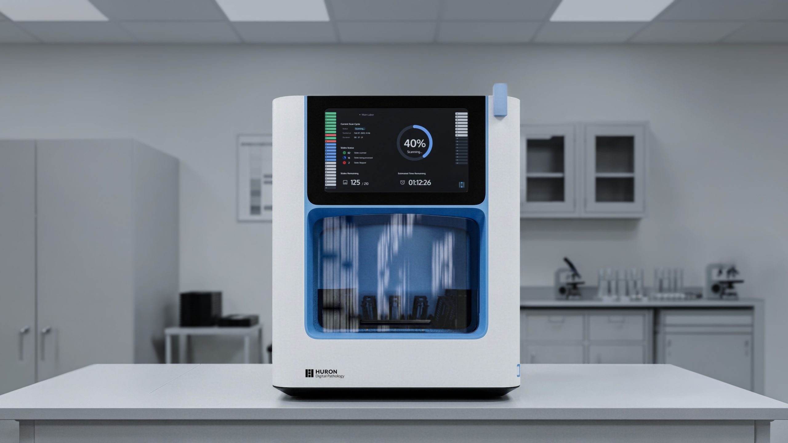 Medical device with front display and internal components visible through a blue-tinted window in a lab setting.